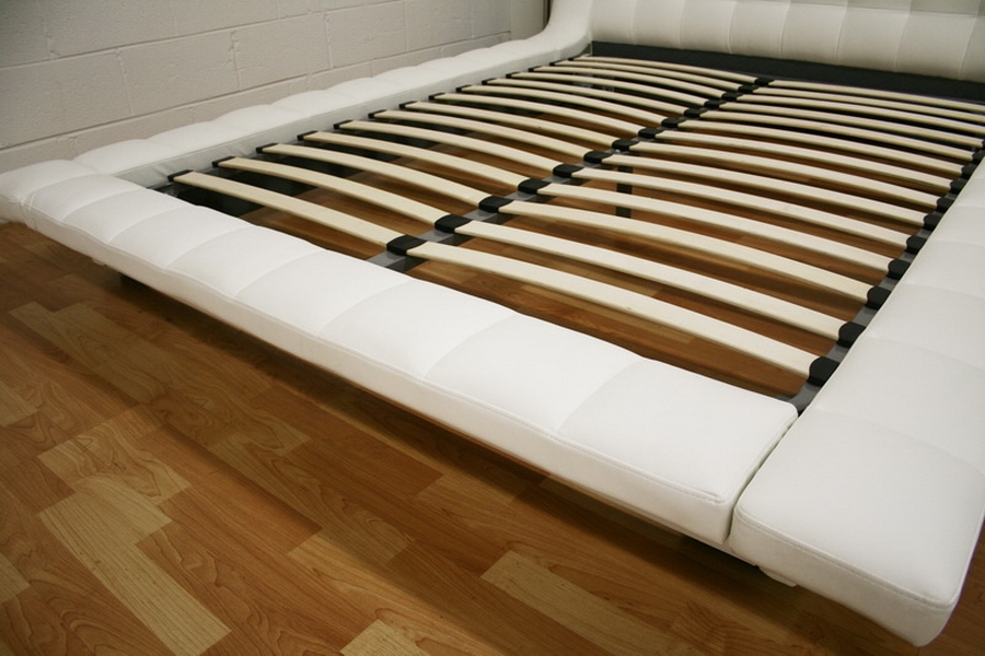 the contemporary design of this padded upholstered platform bed helps 